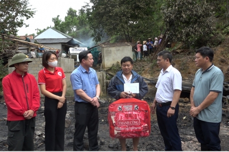 Đồng chí Nguyễn Anh Dũng, PCT UBND huyện động viên trao tiền hỗ trợ cho gia đình anh Lương Đức Tài, bản Mai 3 xã Minh Tân bị cháy nhà